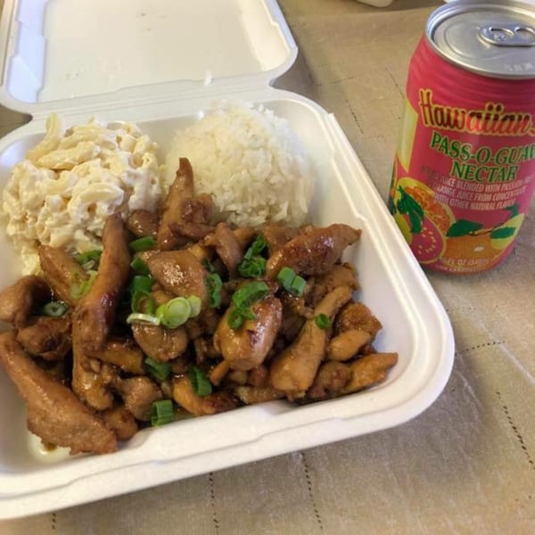 Polynesian chicken, macaroni salad, and rice in a takeout container with a Hawaiian Pass-O-Guava Nectar.