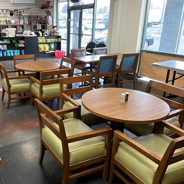 Interior of Leilani's Polynesian Place with wooden tables and chairs, and retail shelves in the background.